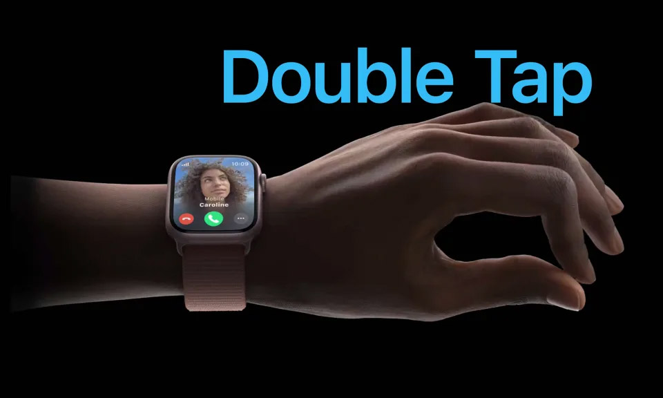 Double Tap. A hand wearing an Apple Watch makes the double tap gesture with the index finger and thumb.