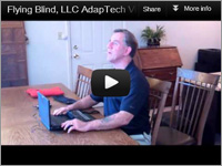 YouTube Video Thumbnail showing Larry Lewis of Flying Blind, LLC sitting at a large table with a Brailliant in front of him.